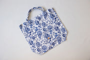 Blue floral apron on a light gray background
