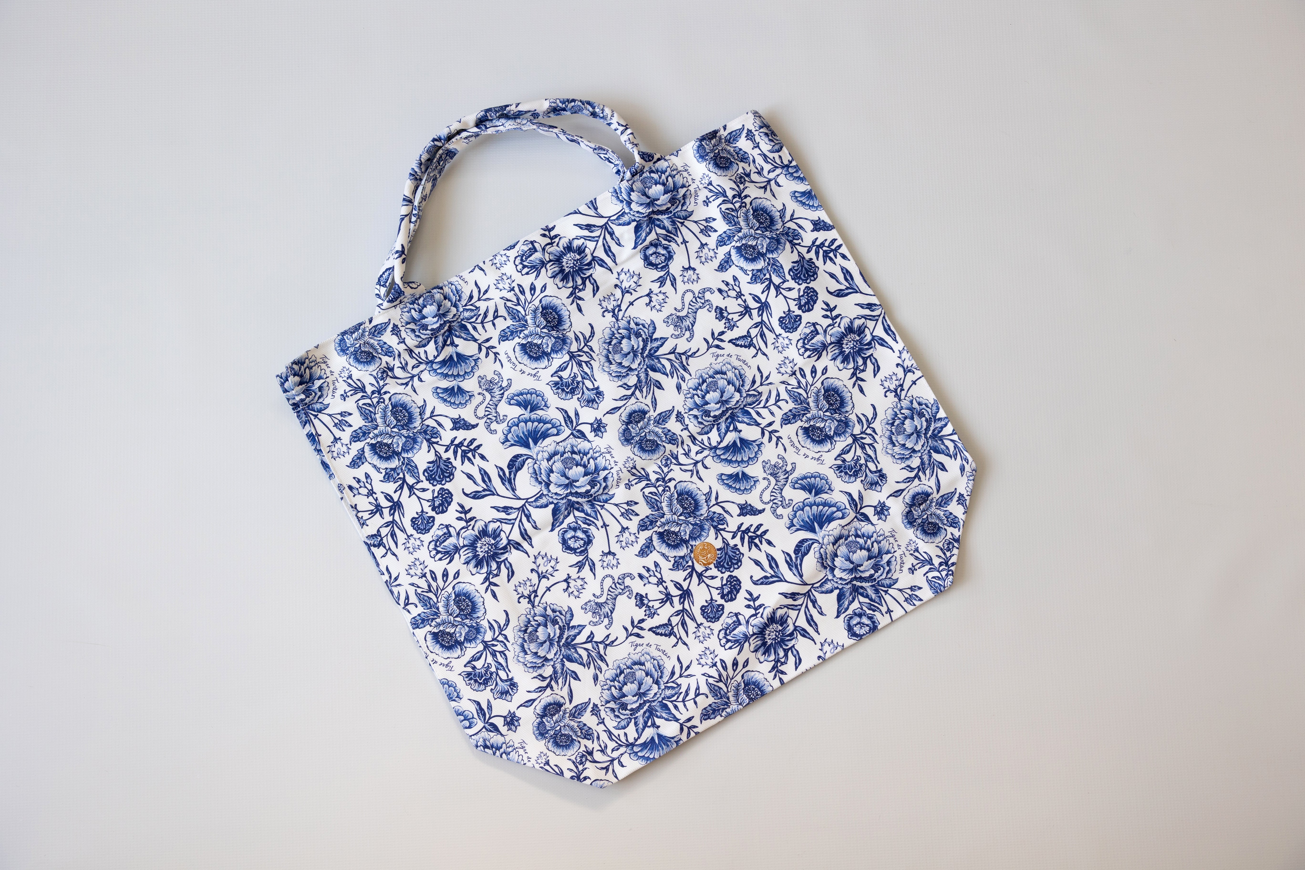 Blue floral apron on a light gray background
