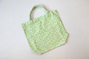 Green floral-patterned tote bag on a light gray background