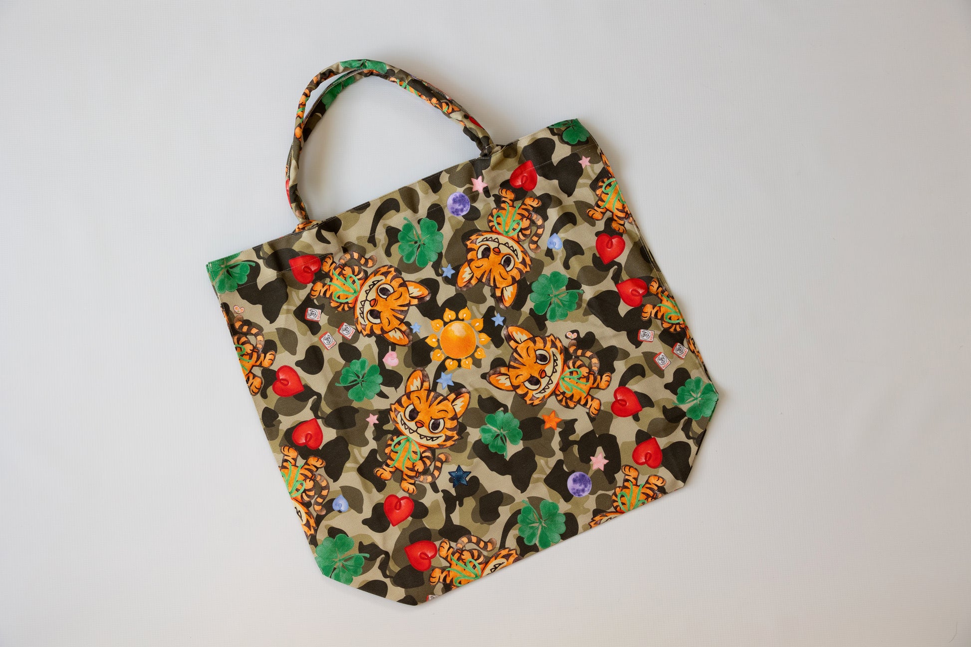 Leopard print bag with colorful floral patterns on a white background