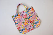 Floral patterned reusable bag on a white background