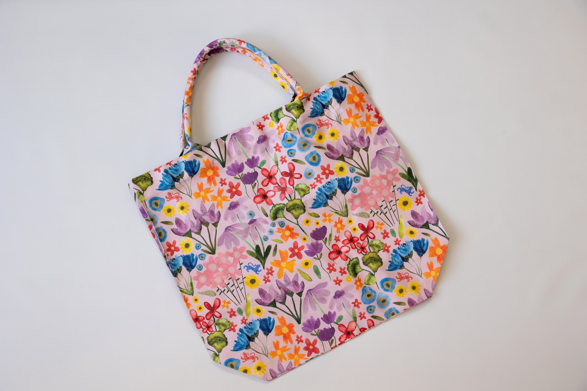 Floral patterned reusable bag on a white background