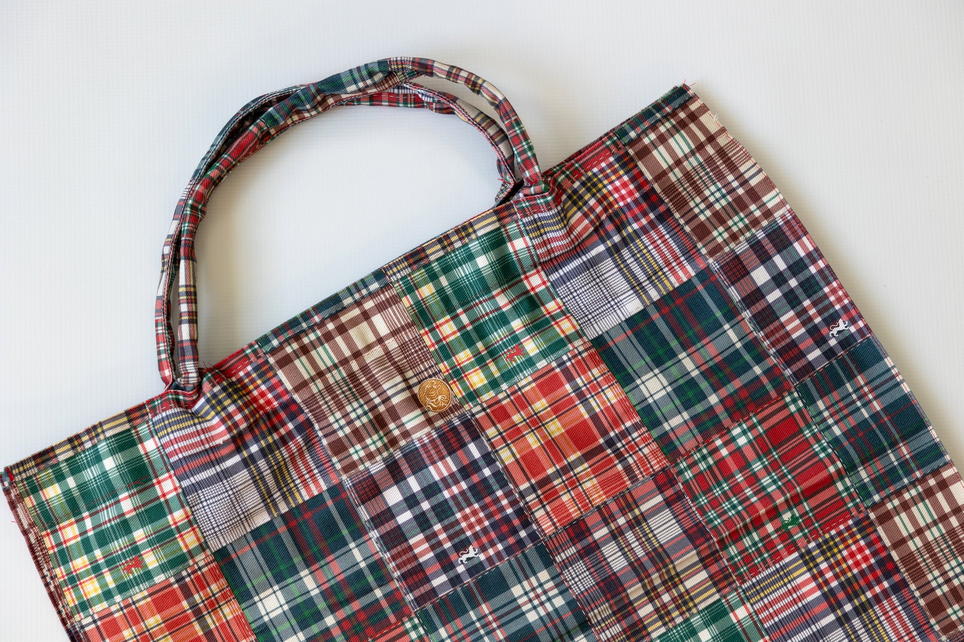 Plaid patterned bag on a white background