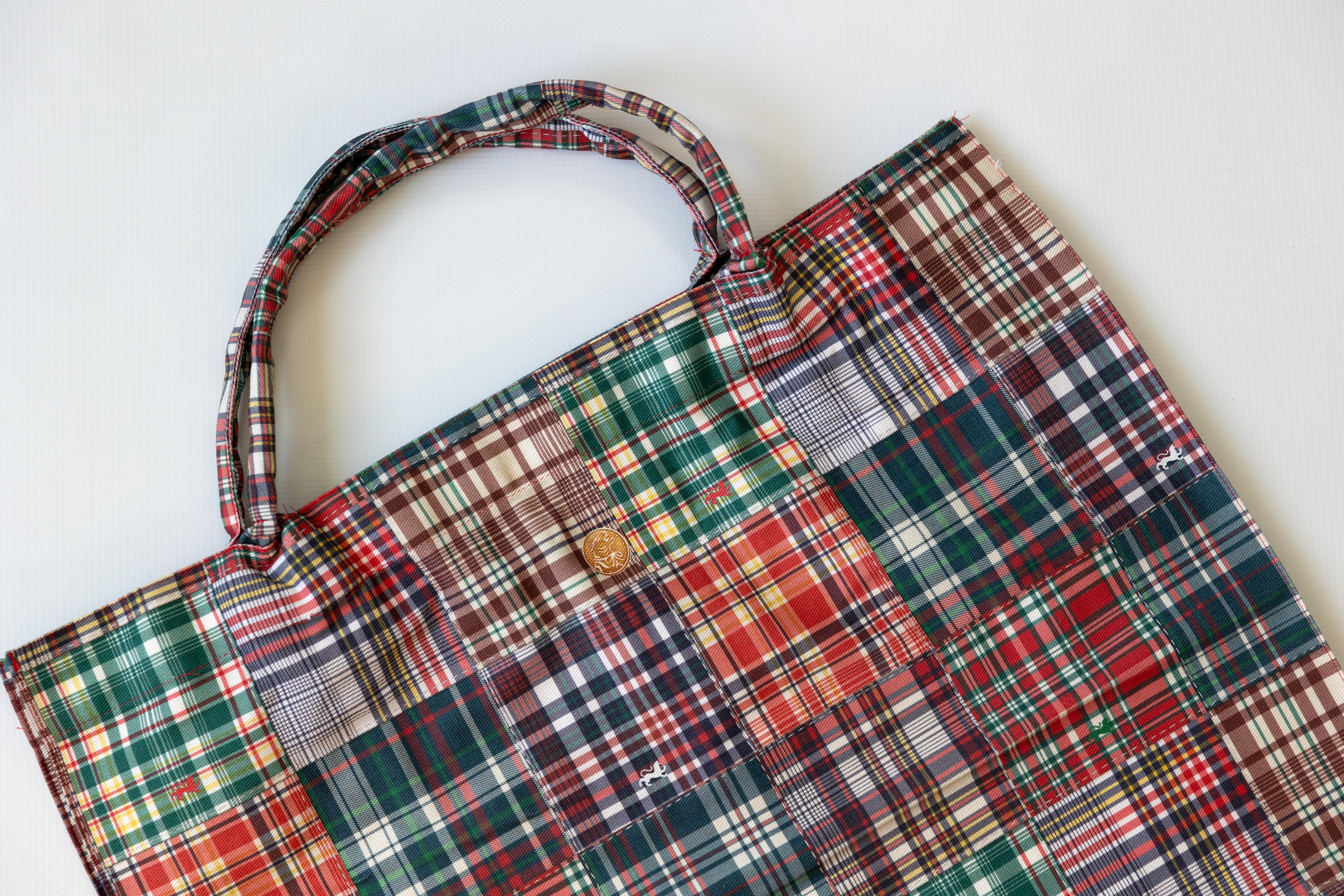 Plaid patterned bag on a white background