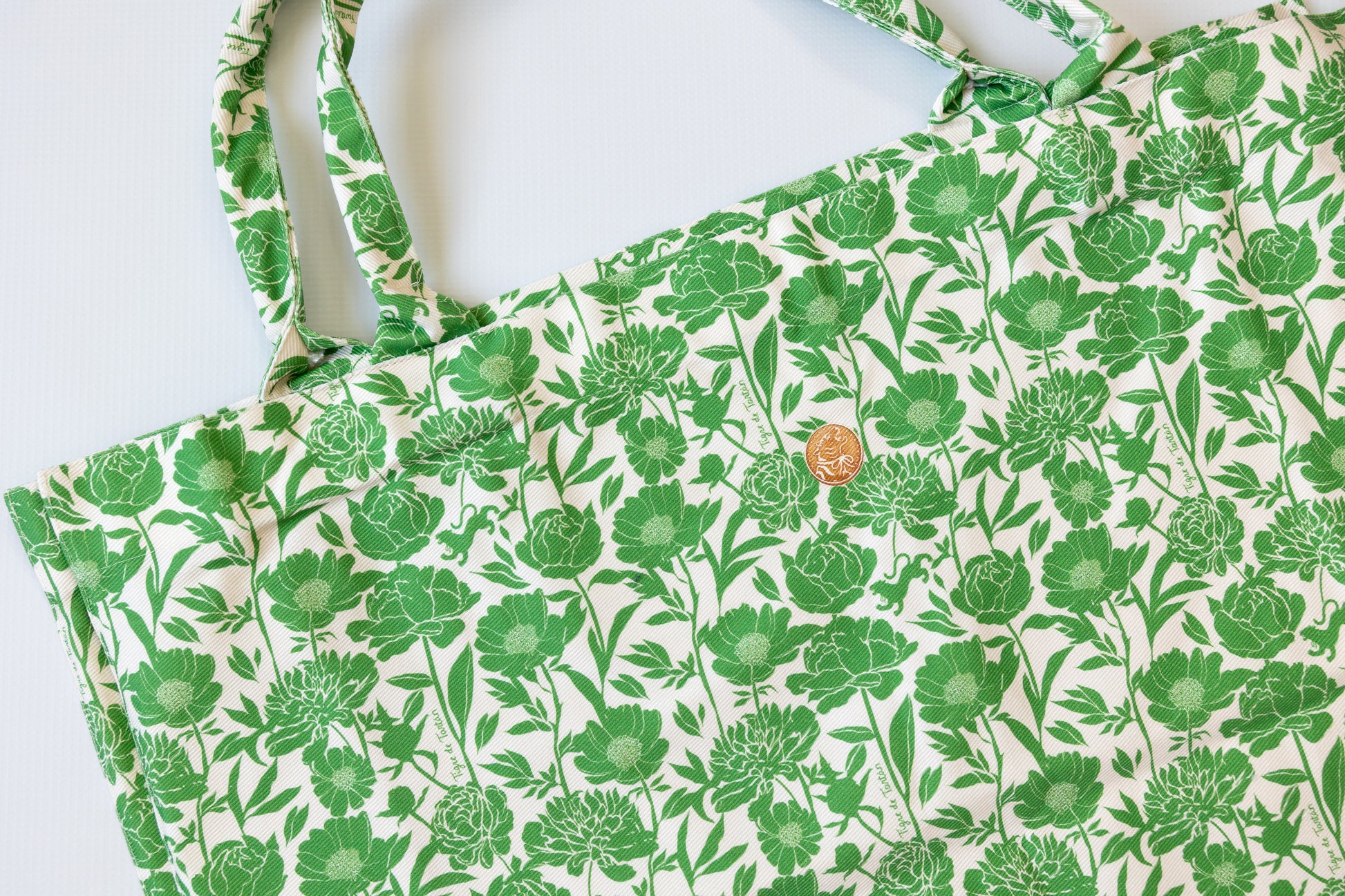 Green floral patterned fabric on a white background