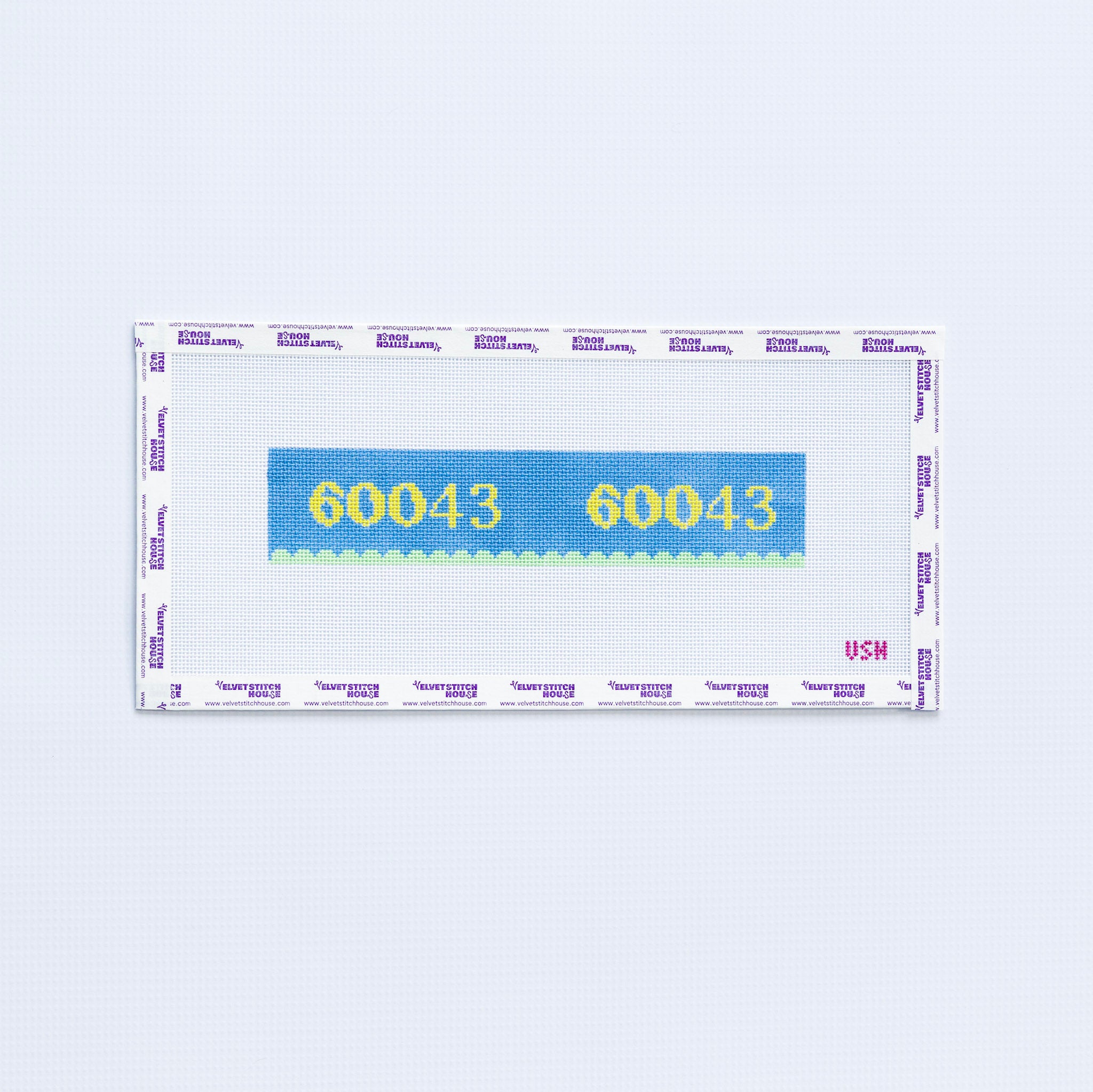 Needlepoint pattern key fob with 60043 zip code in yellow on a blue background with green scallop edge. 