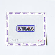 Needlepoint pattern with 'LYLAS' text on a white fabric background love you like a sister
