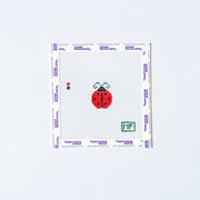 Needlepoint design of mini red ladybug on white canvas