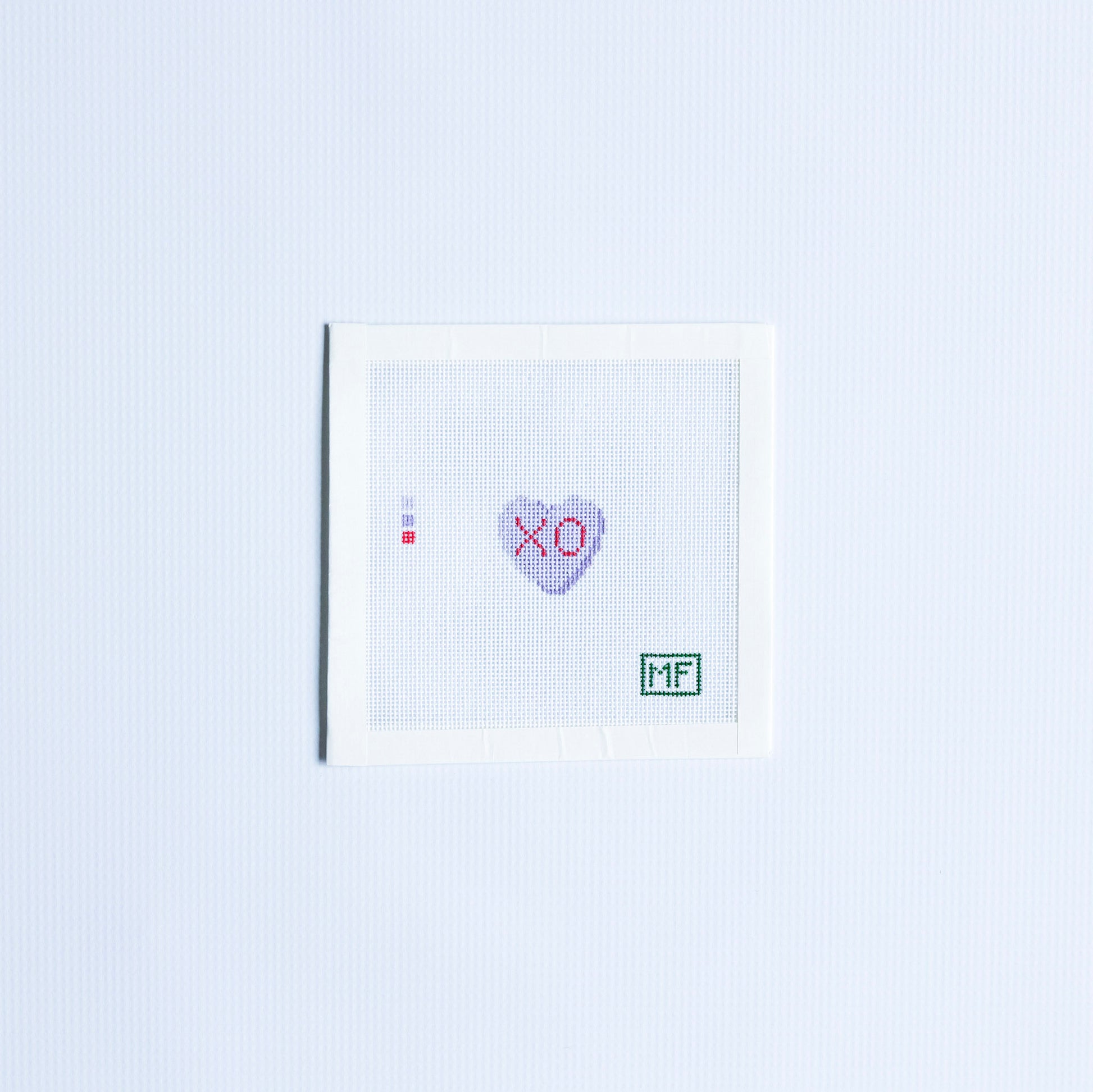Mini needlepoint pattern with a purple heart and 'XO' text in red.