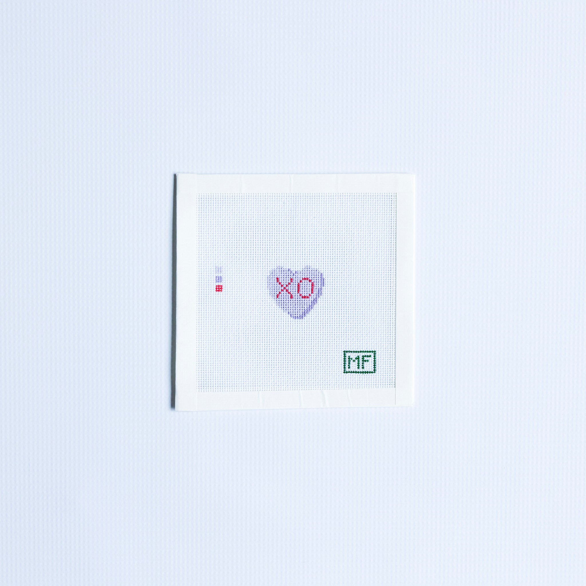 Mini needlepoint pattern with a purple heart and 'XO' text in red.