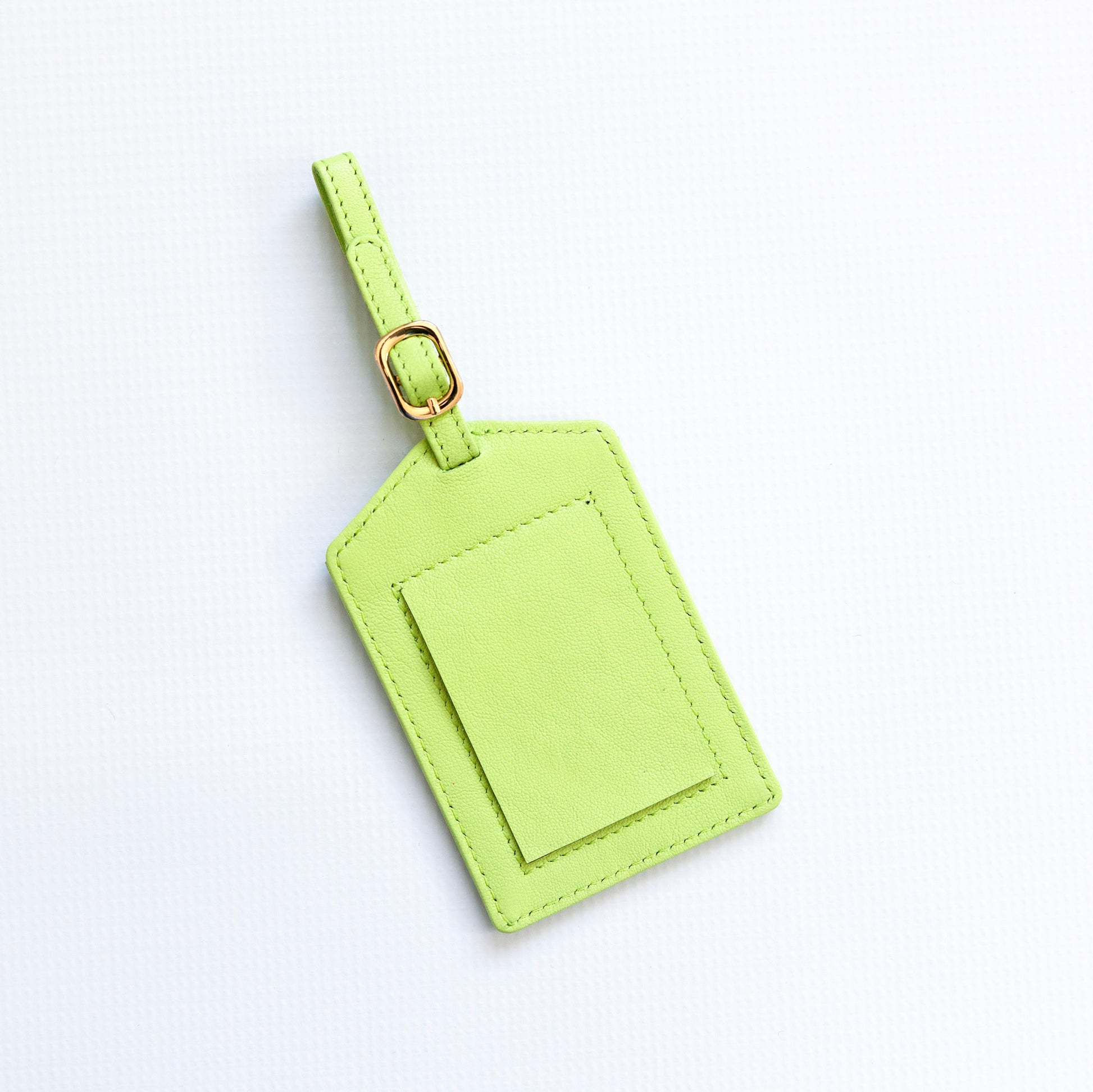 Green luggage tag on a white background