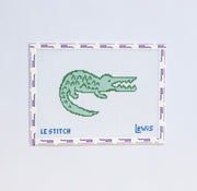 Needlepoint pattern of a green alligator design on a white background