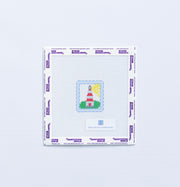 Needlepoint design of a mini red and white  lighthouse on a white fabric with a blue border.