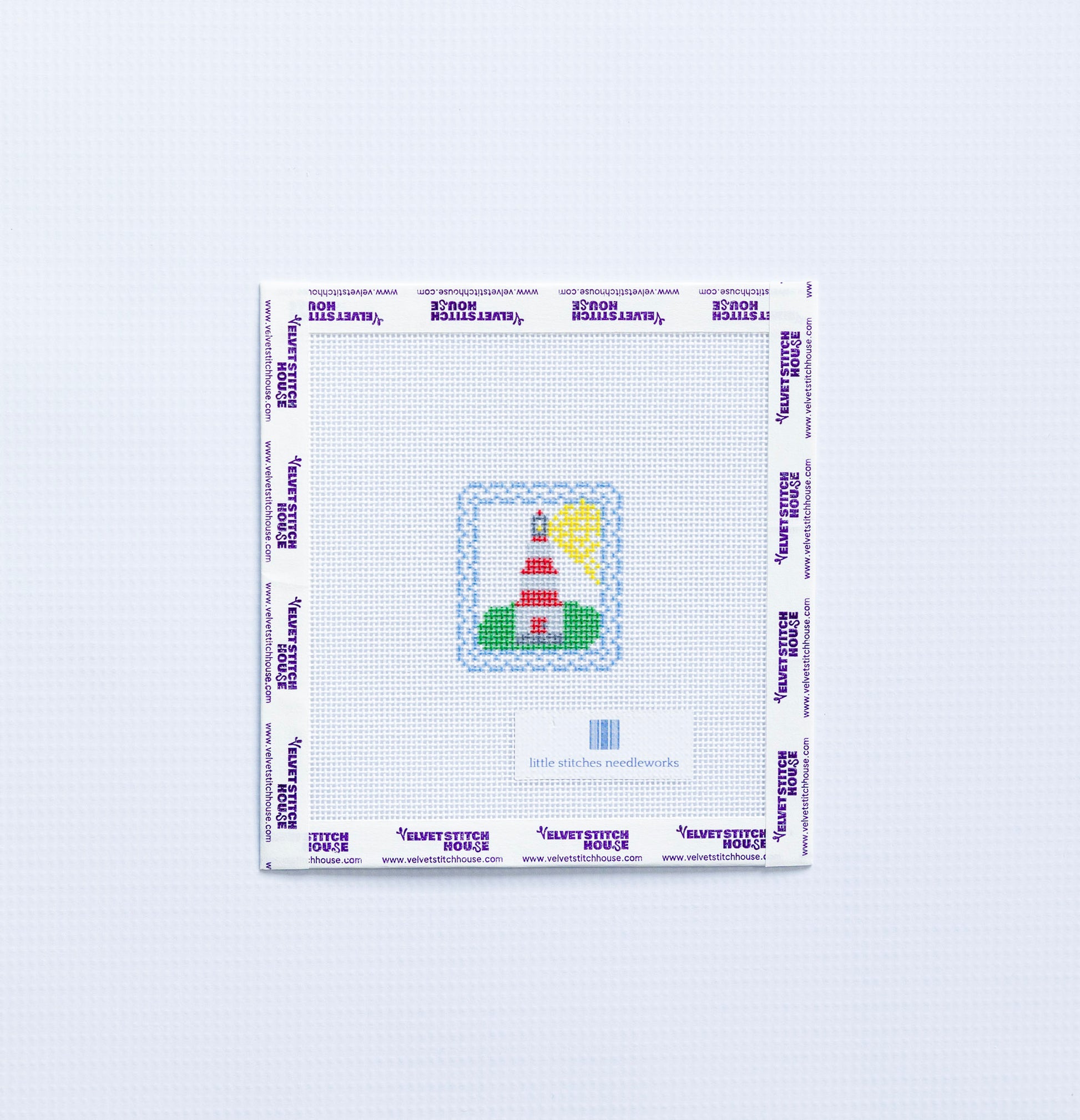 Needlepoint design of a mini red and white  lighthouse on a white fabric with a blue border.