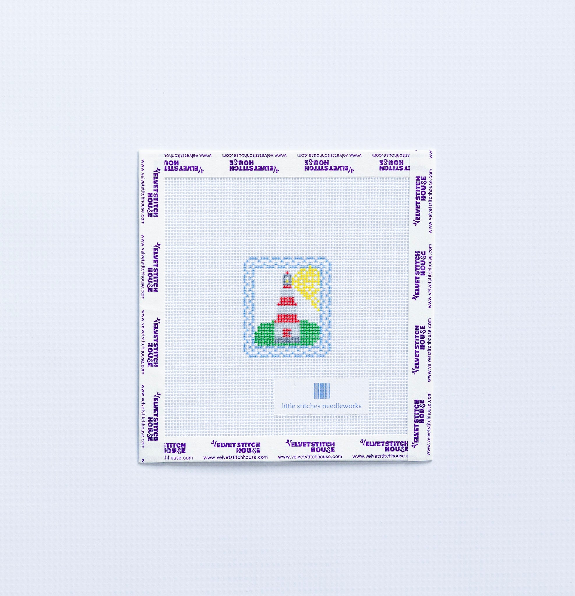 Needlepoint design of a mini red and white  lighthouse on a white fabric with a blue border.