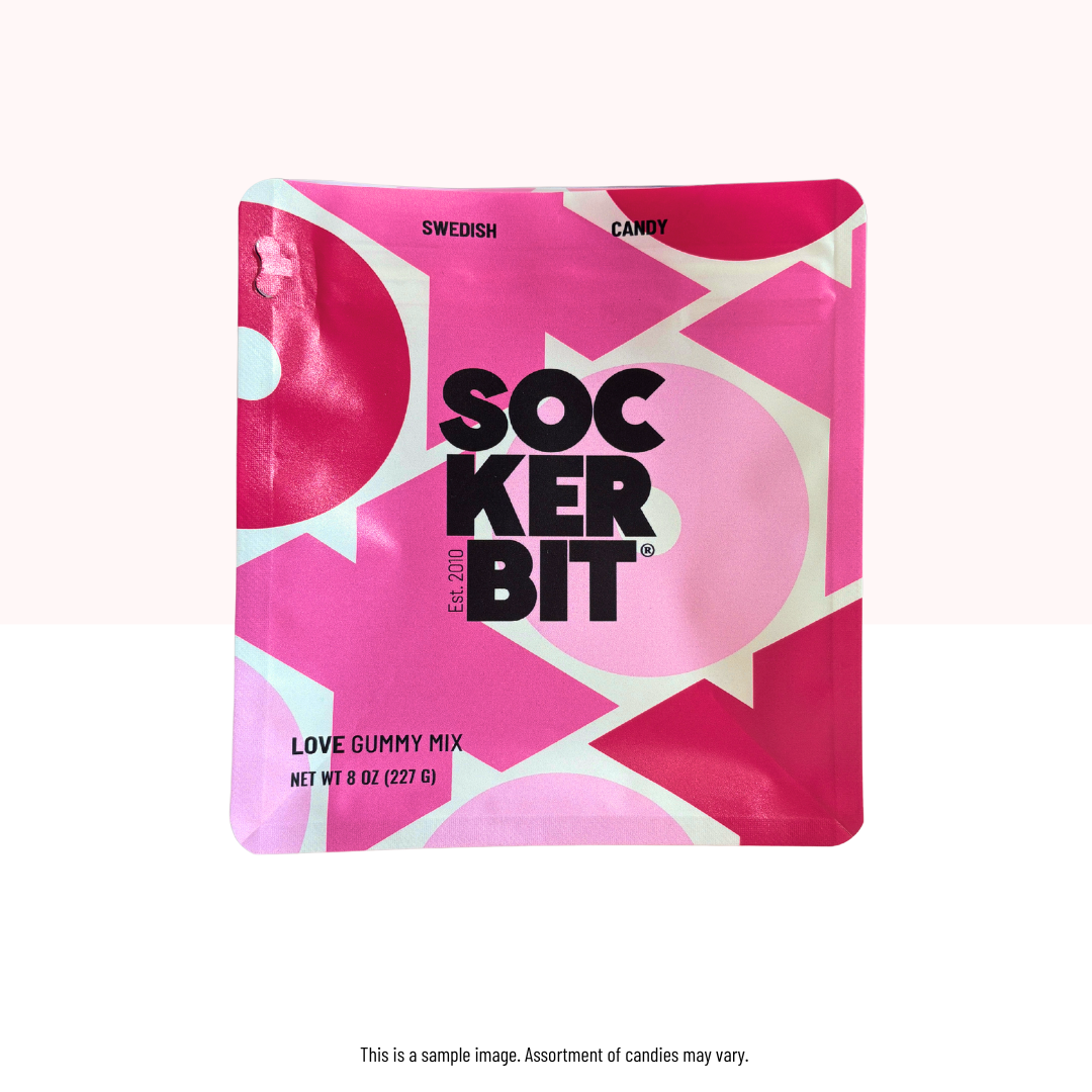 Pink packaging of Sockerbit candy with geometric design on a white background