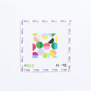 Needlepoint coaster pattern with colorful geometric circles on a white background