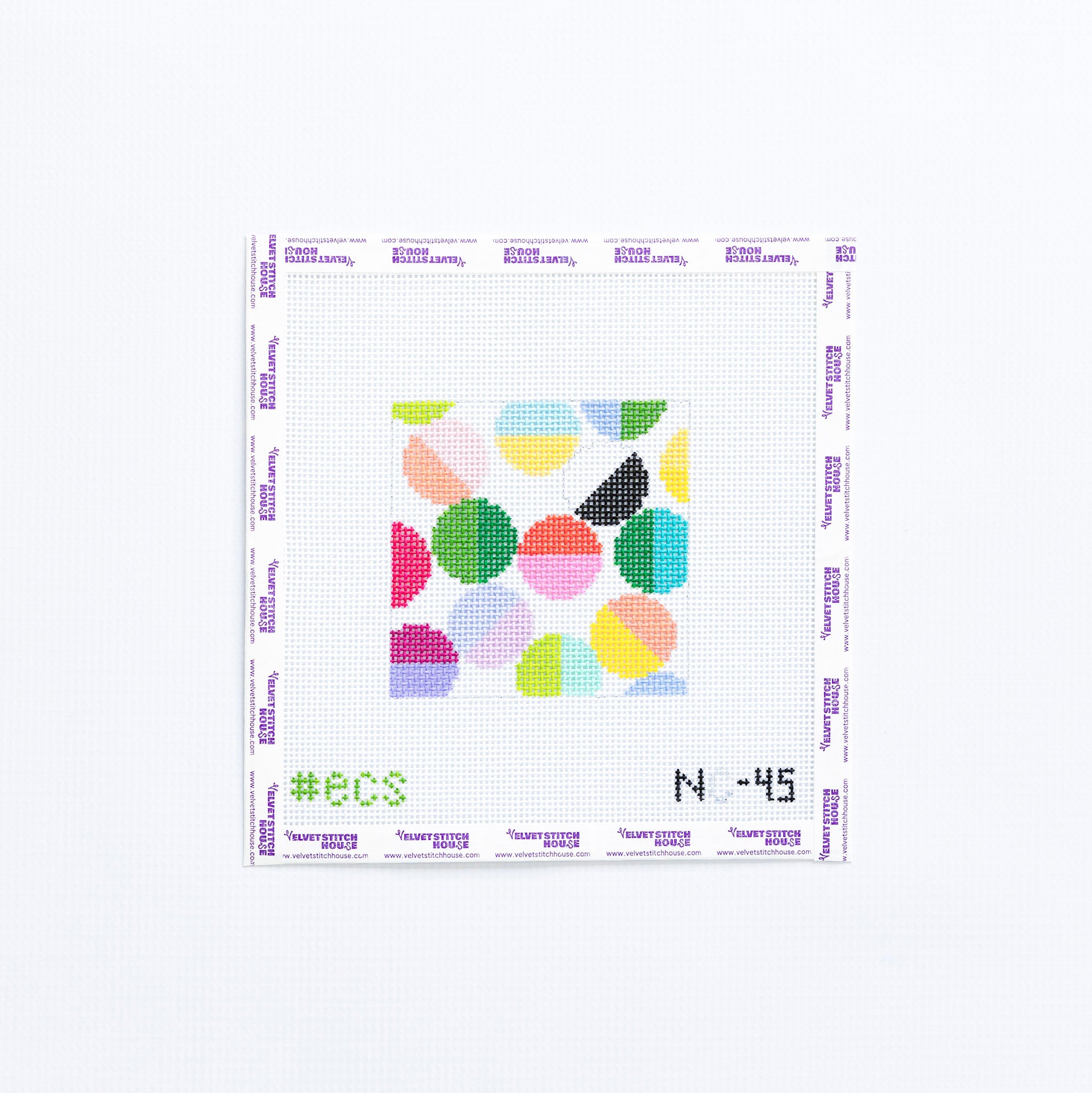Needlepoint coaster pattern with colorful geometric circles on a white background