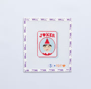 Needlepoint design of a joker elf design on a mahjong JOKER tile on a white background