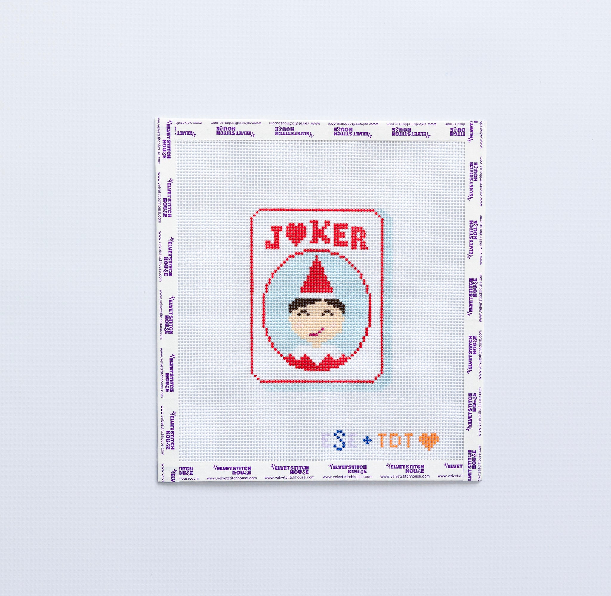 Needlepoint design of a joker elf design on a mahjong JOKER tile on a white background
