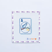 Needlepoint design with a blue partridge bird and branch pattern on a 1 mahjong tile on a white background. 