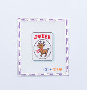 Needlpoint design of a reindeer on a JOKER mahjong tile on a white background