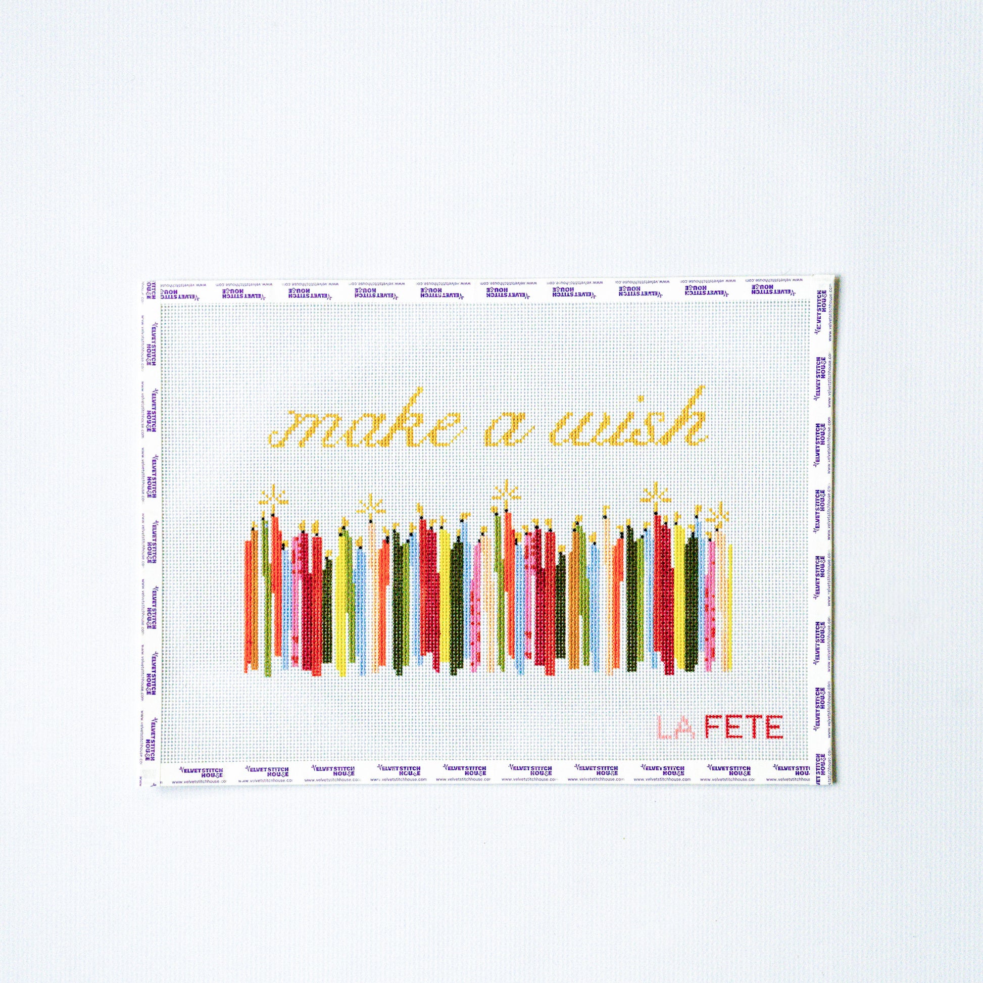 Decorative needlepoint design with colorful candles and 'make a wish' text on a white background