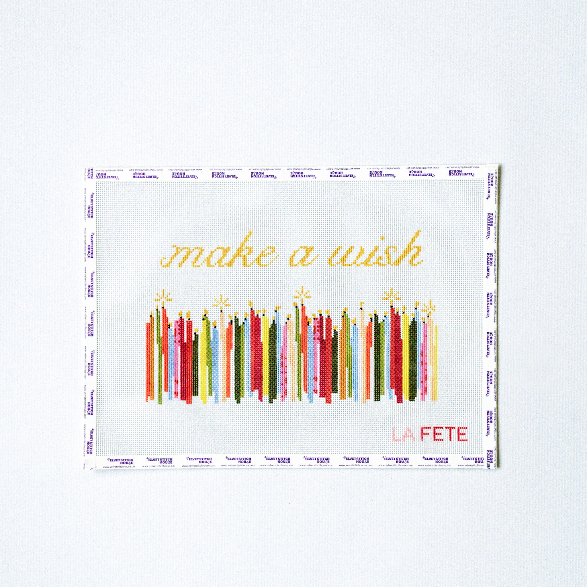 Decorative needlepoint design with colorful candles and 'make a wish' text on a white background