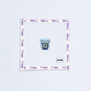 Needlepoint pattern with a mini blue and green jam jar on a white background