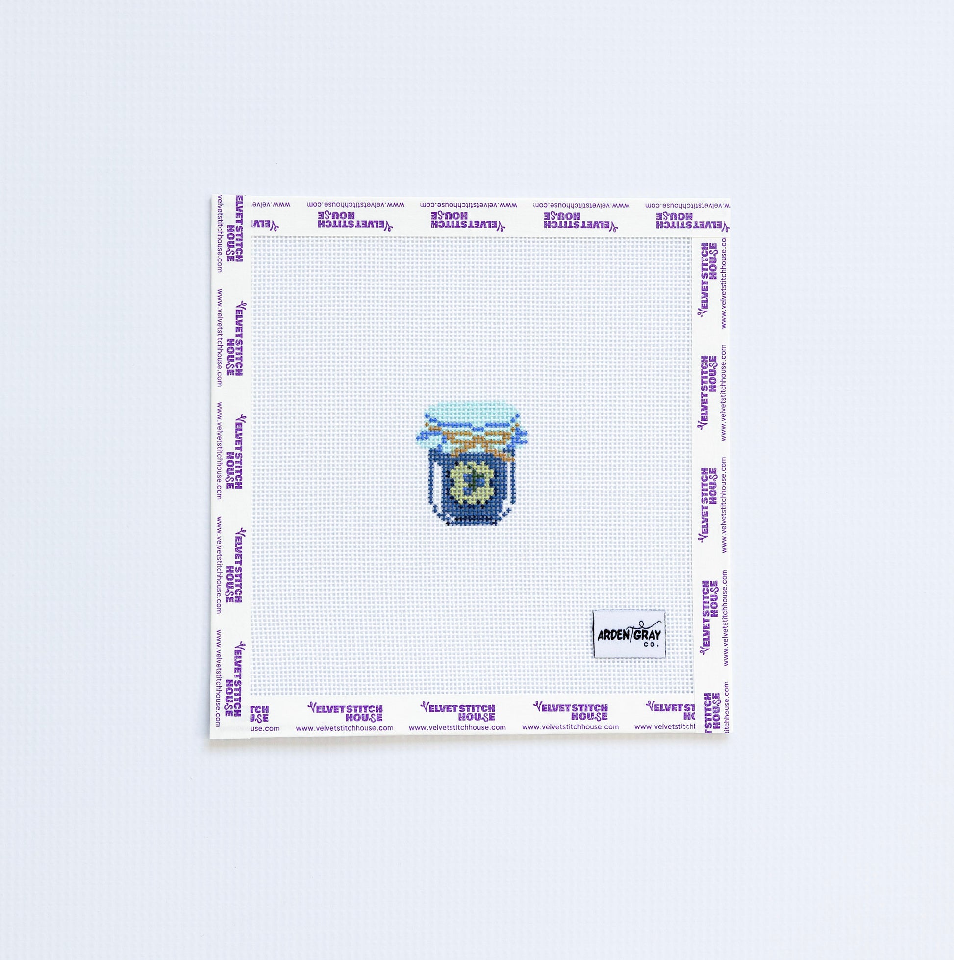 Needlepoint pattern with a mini blue and green jam jar on a white background