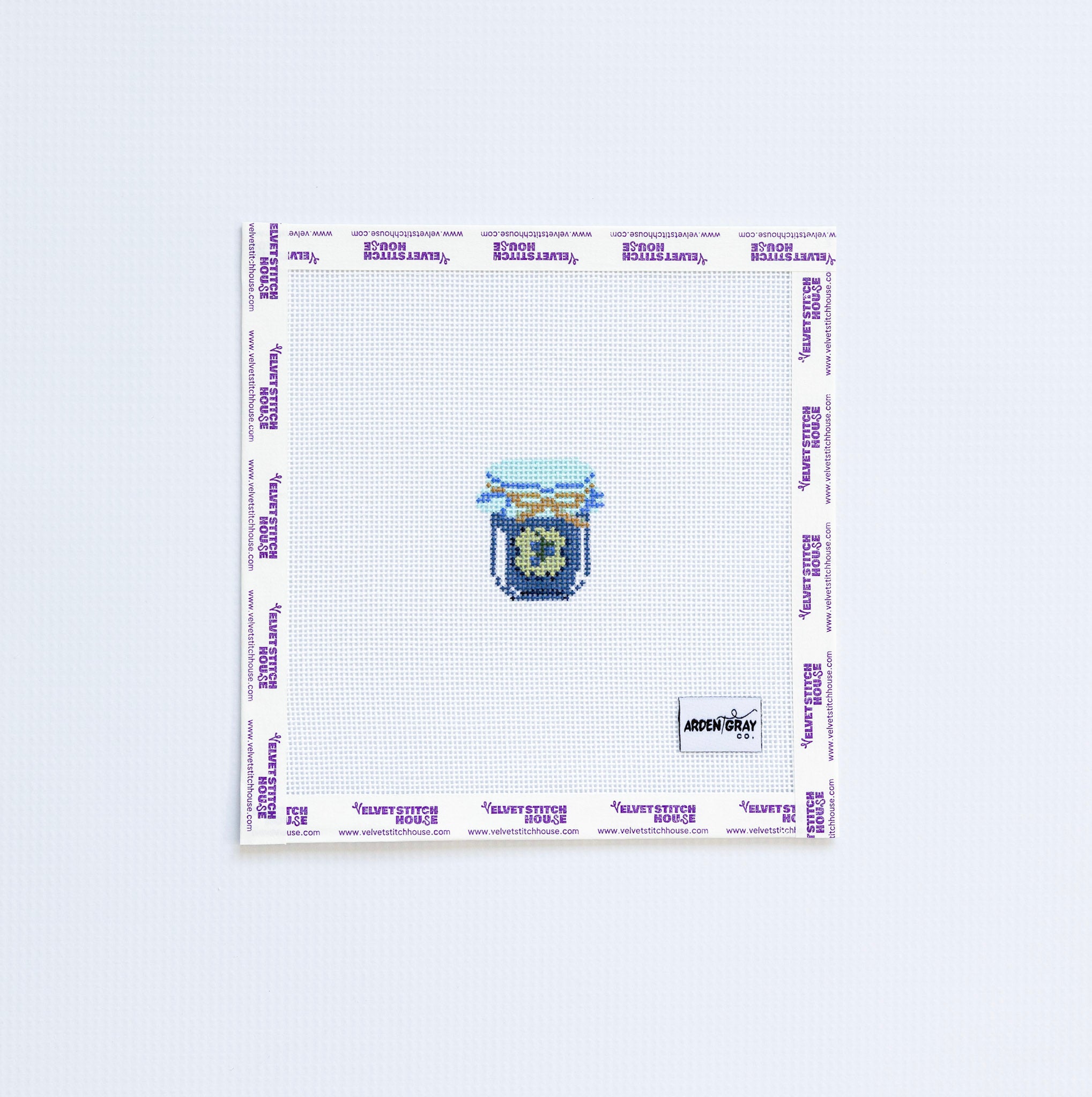 Needlepoint pattern with a mini blue and green jam jar on a white background