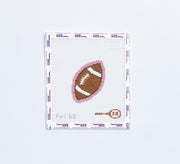 Needlepoint pattern of a football on fabric with a light pink border