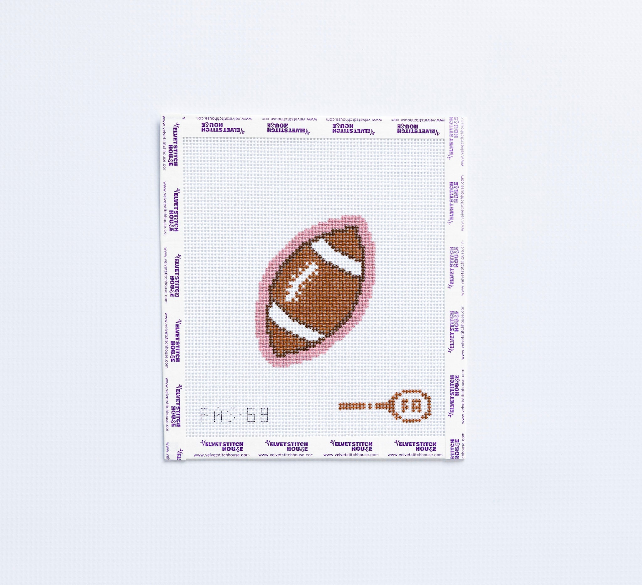 Needlepoint pattern of a football on fabric with a light pink border