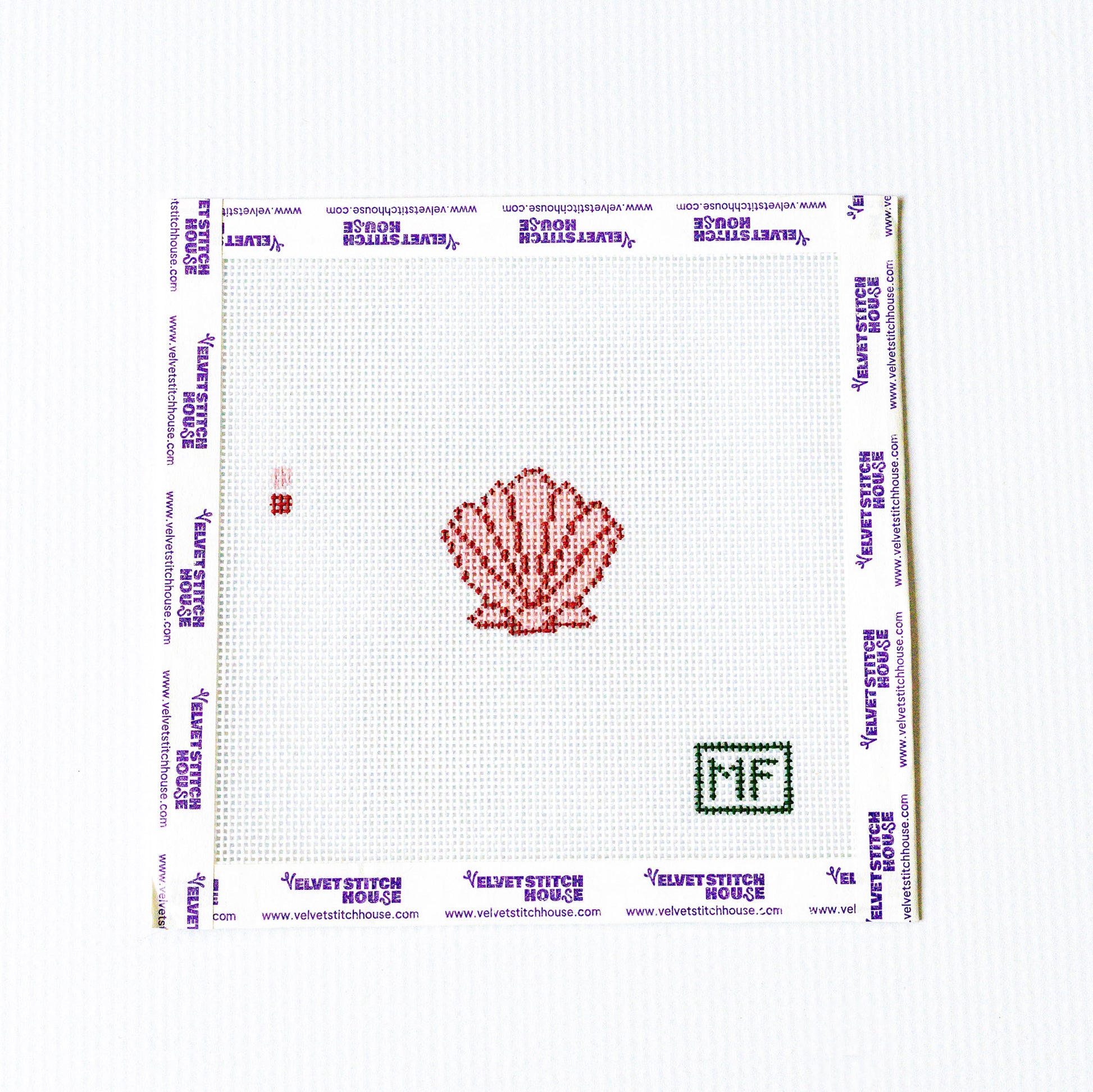 Needlepoint pattern with a red and pink shell design on a white background