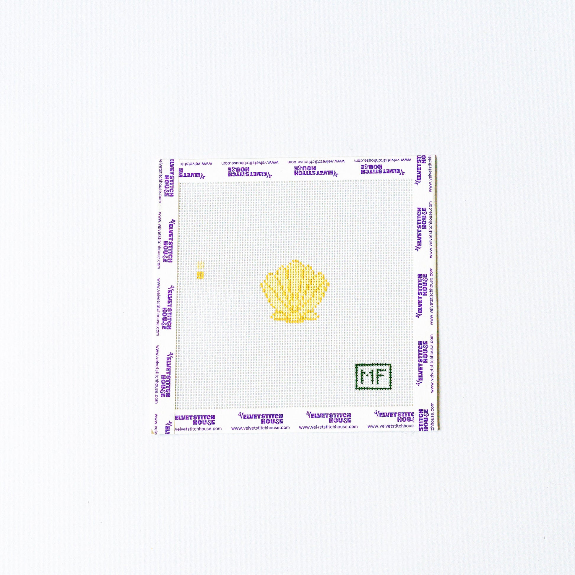 Needlepoint design of a yellow shell with a grid pattern on a white background