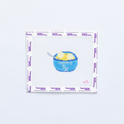 Needlepoint pattern of a blue bowl of matzo ball soup with 'Mom's RX' text on a white background