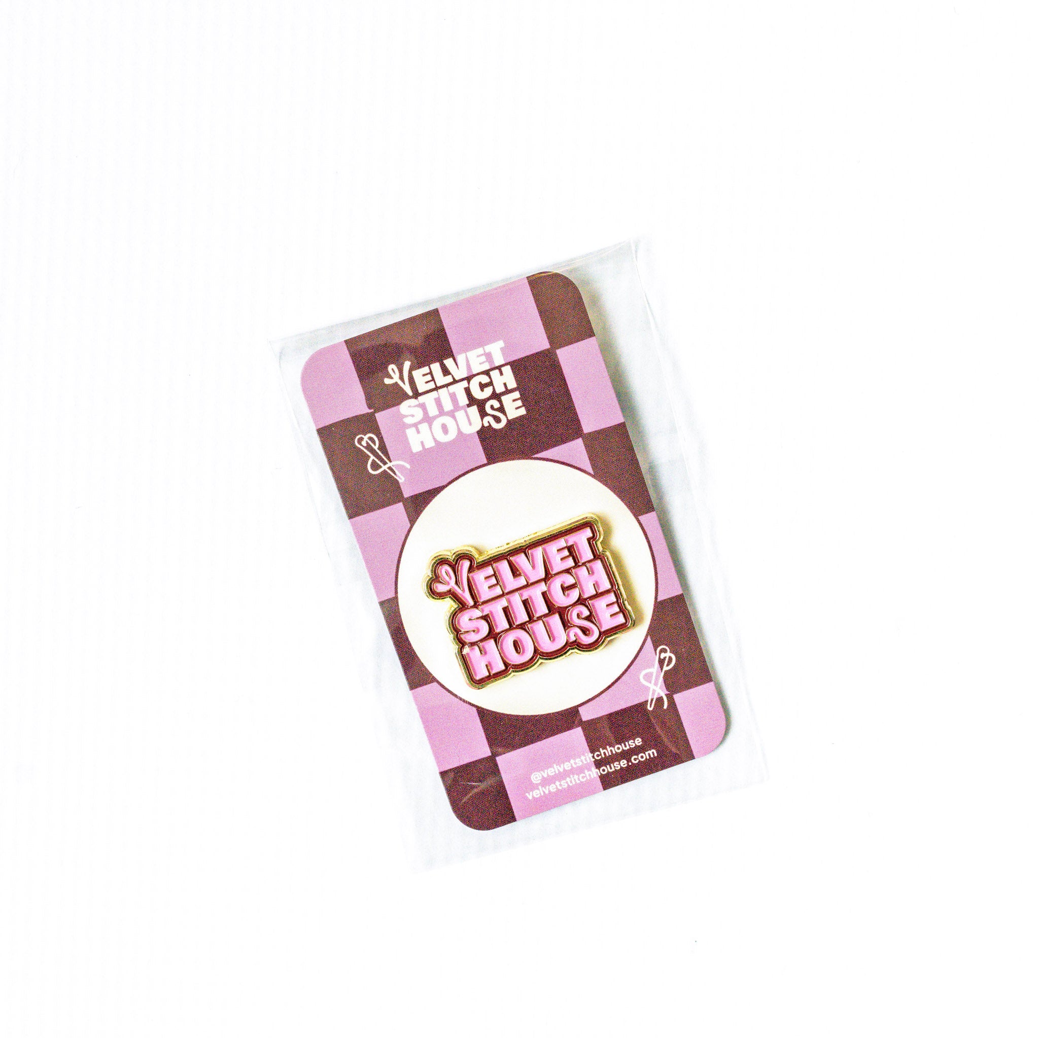 Pink and Red VElvet Stitch House Magnet with checkered pattern on a white background
