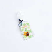 Small pouch with a labubu inspired monster needleminder magnet design on a white background