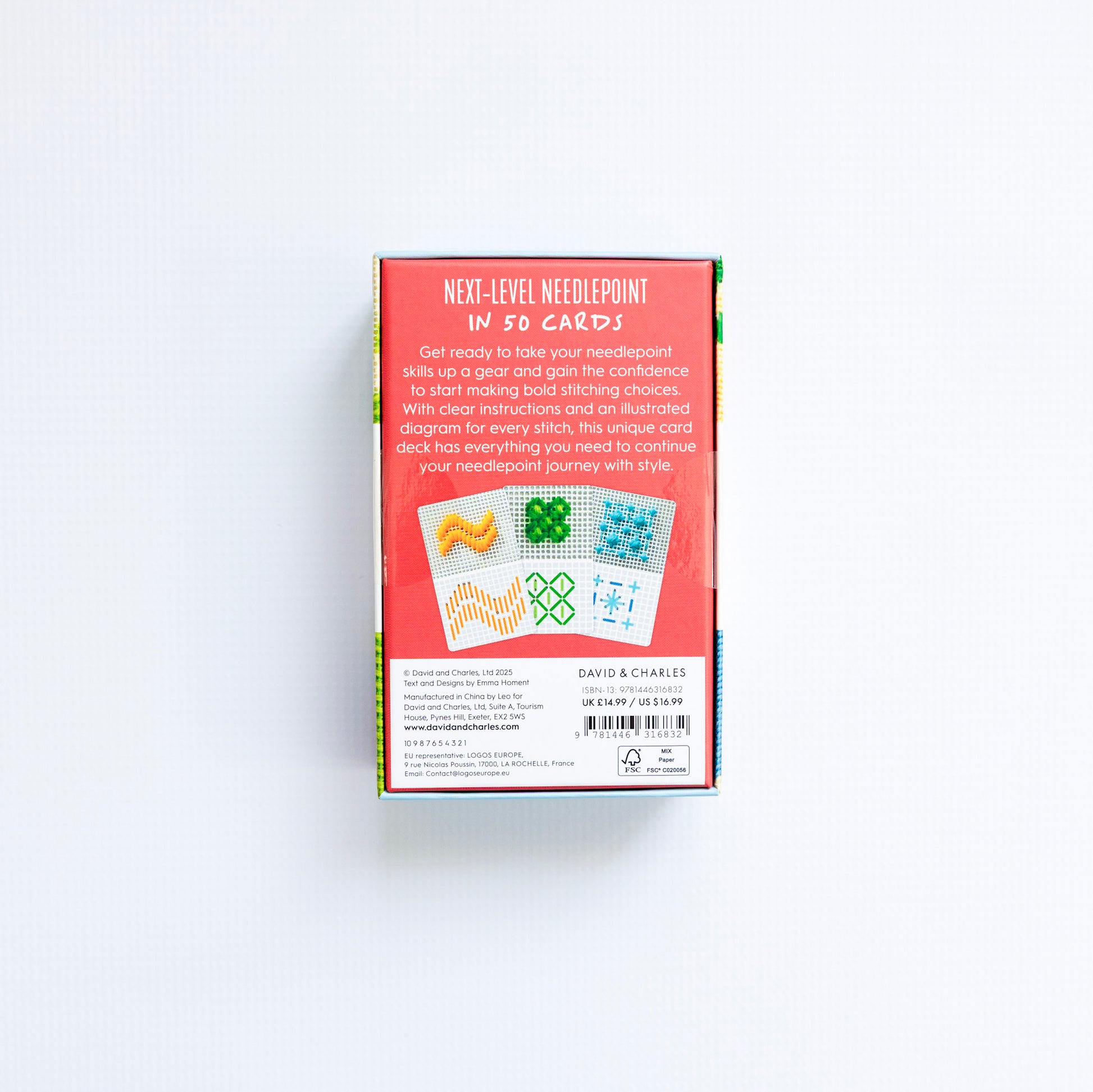 Box of 'Next-Level Needlepoint' cards with colorful designs on a white background