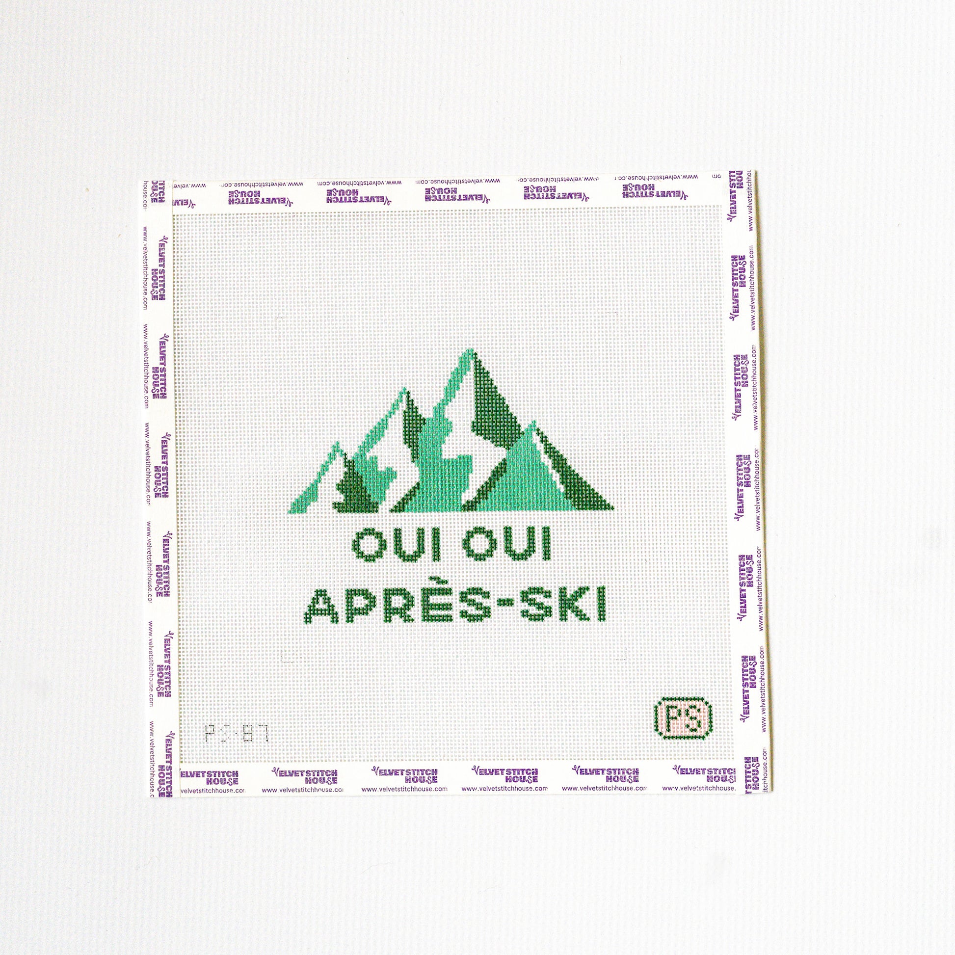 Needlepoint design with green mountains and text on a white background