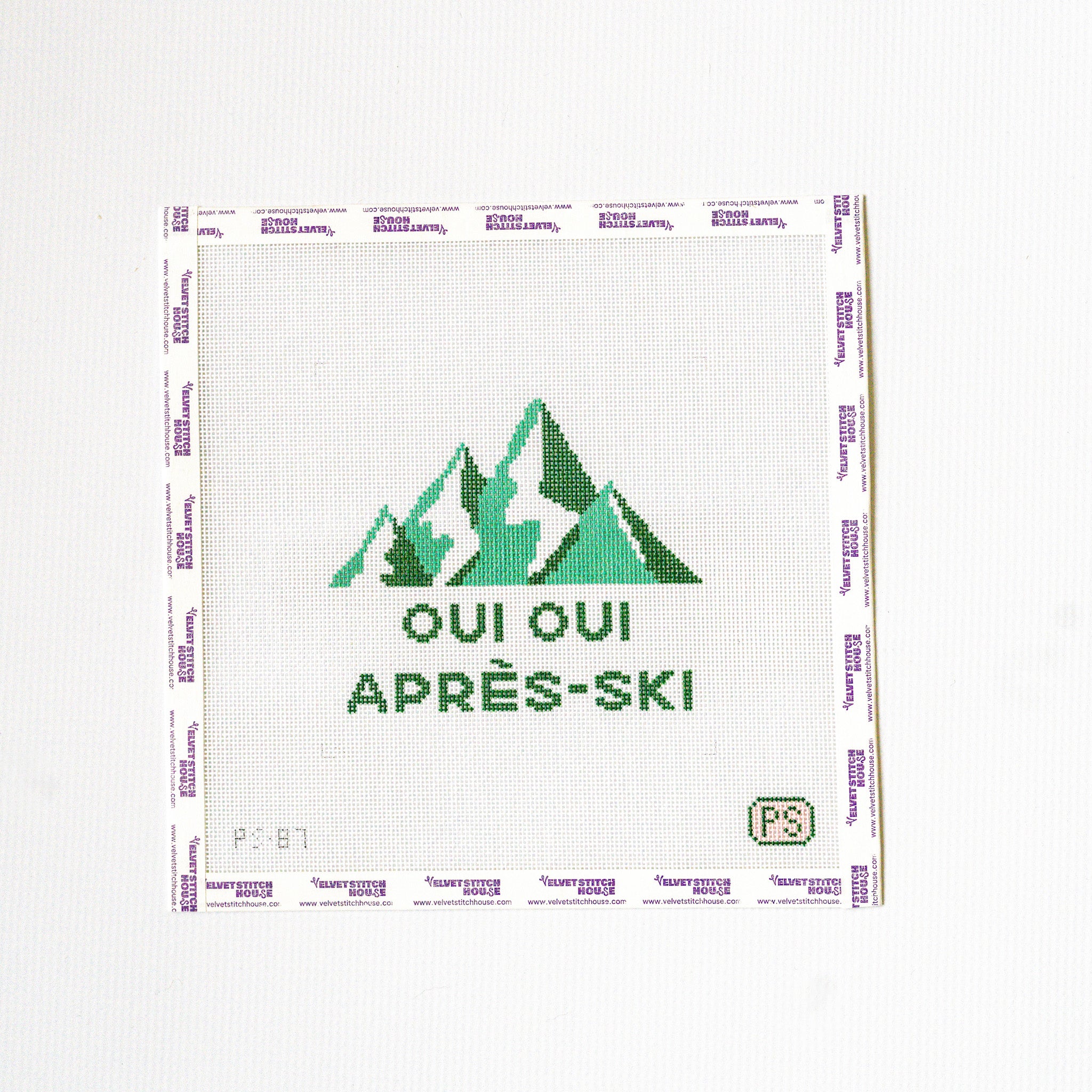 Needlepoint design with green mountains and text on a white background