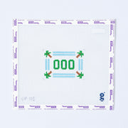Needlepoint pattern with '000' and decorative elements on a grid background