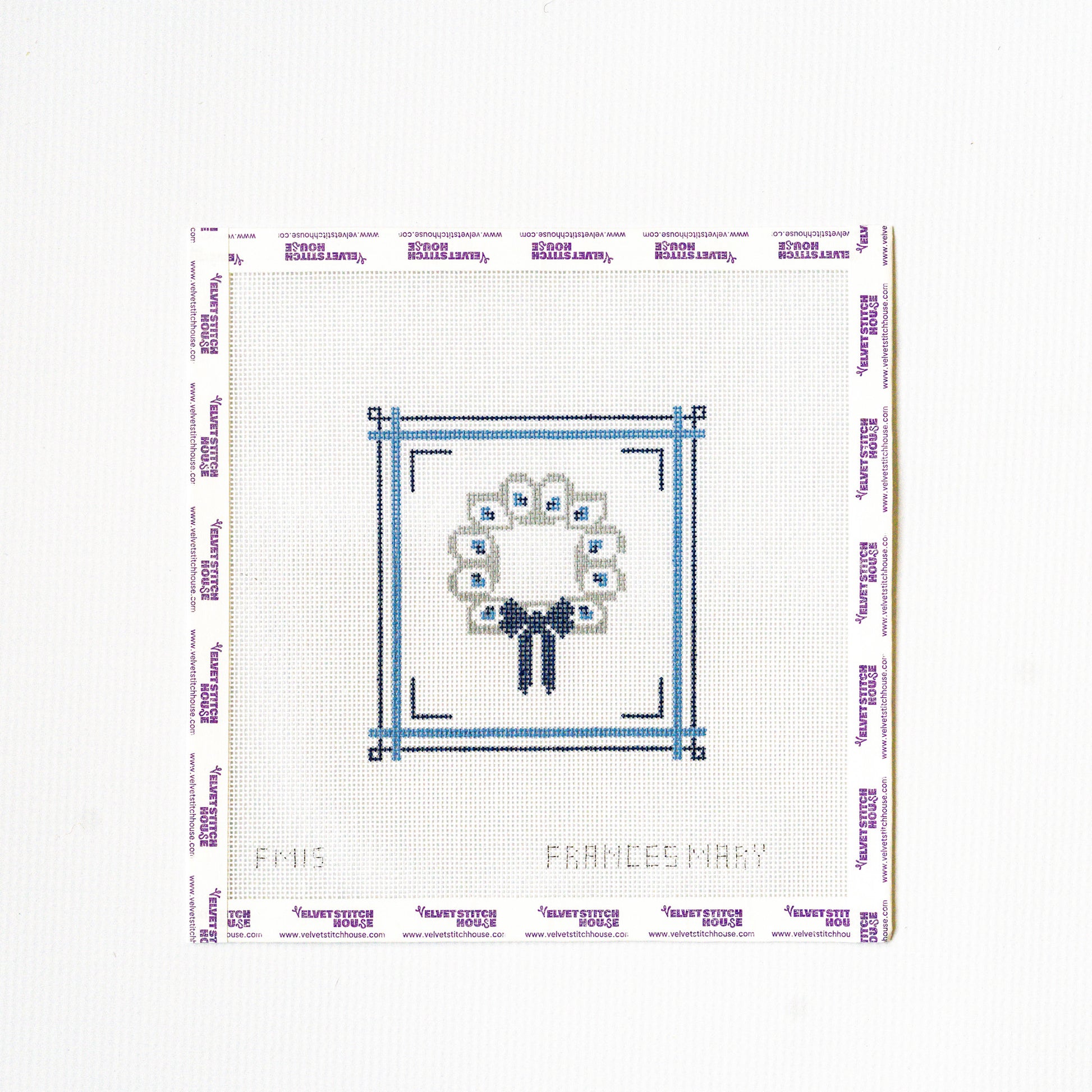 Needlepoint pattern with a flower and bow design on a white background