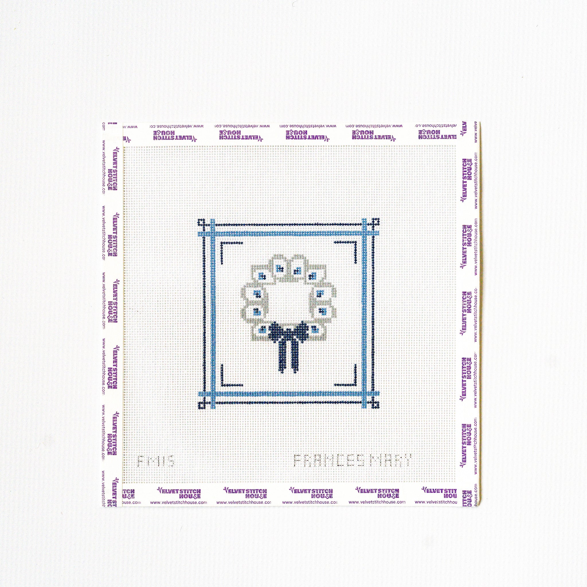 Needlepoint pattern with a flower and bow design on a white background