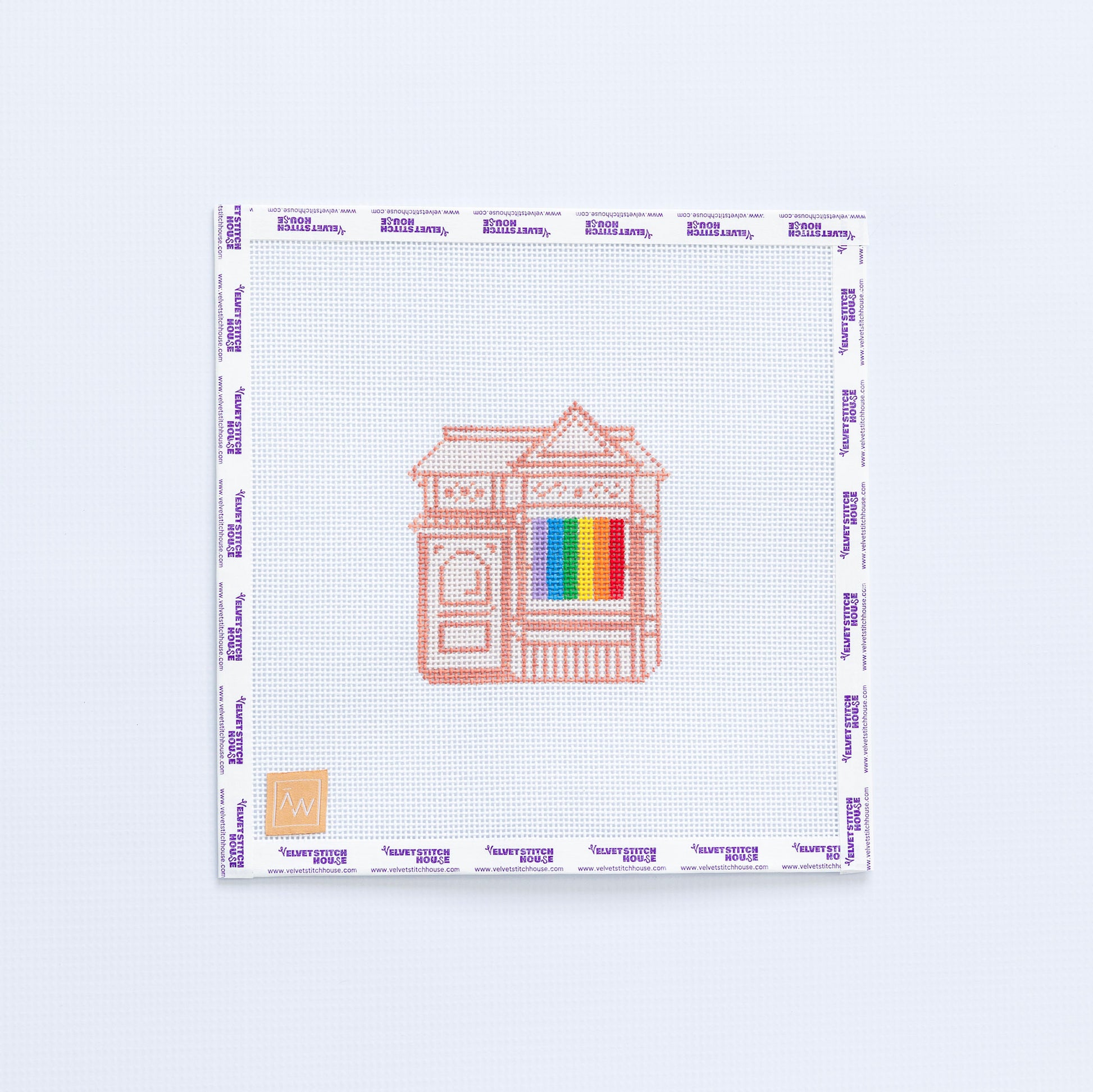 Needlepoint pattern with a house design and a rainbow LGBTQIA flag.