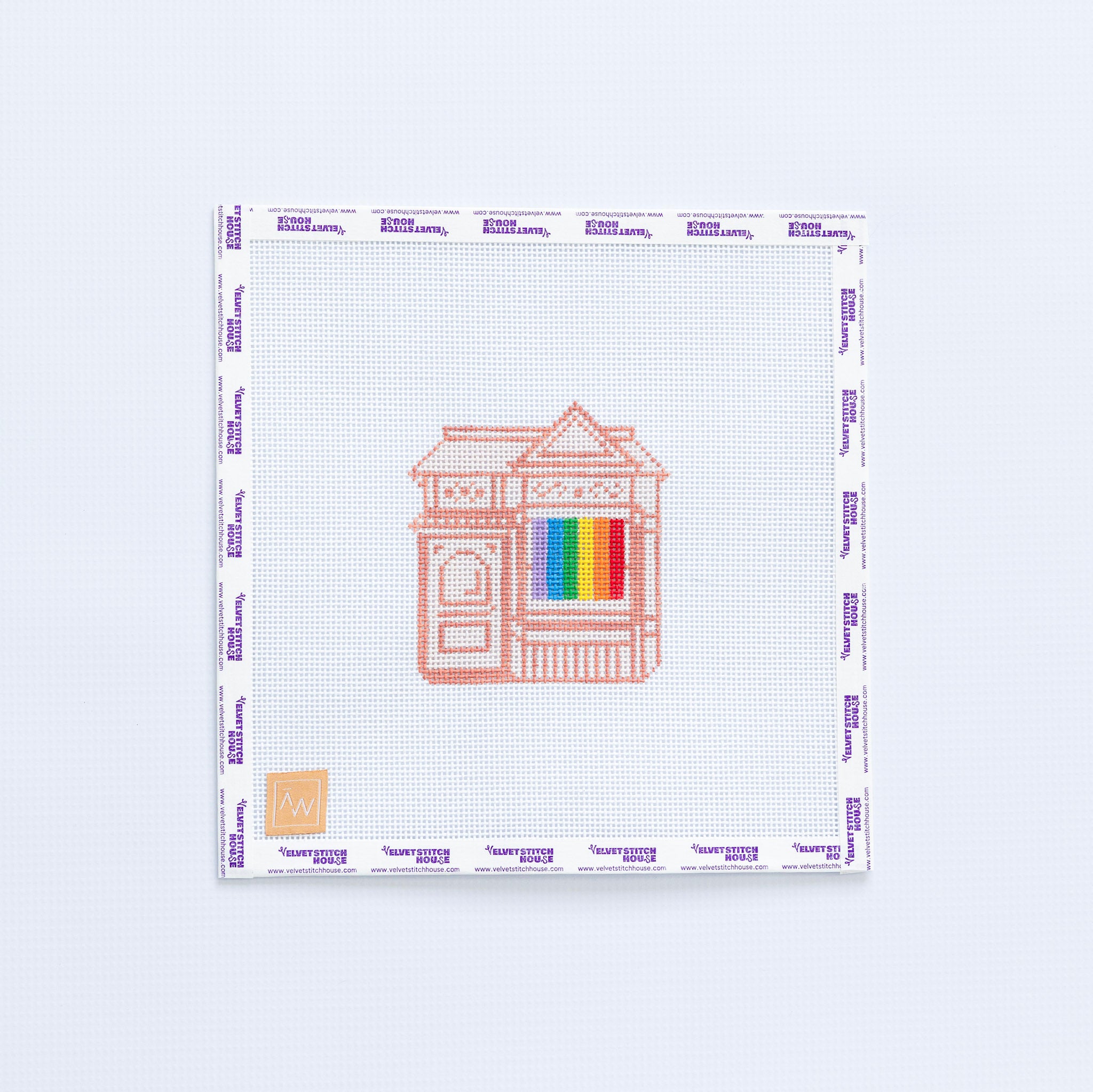 Needlepoint pattern with a house design and a rainbow LGBTQIA flag.