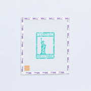 Needlpoint design of a with a green stamp design featuring the Statue of Liberty on a white background