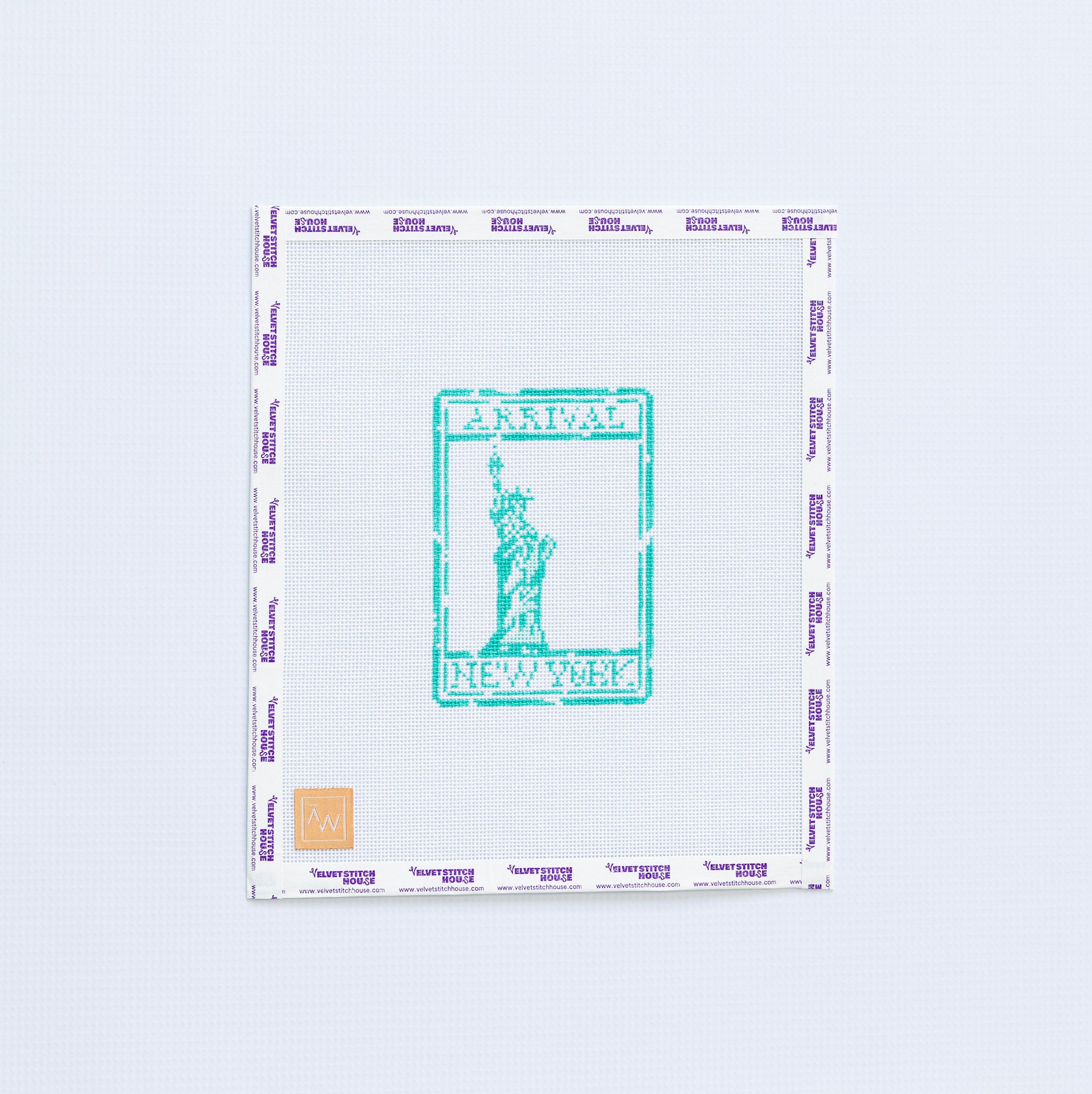 Needlpoint design of a with a green stamp design featuring the Statue of Liberty on a white background
