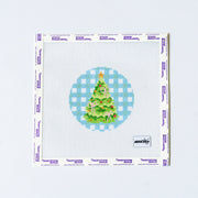 Needlepoint pattern of a green Christmas tree design with pink bows on a blue gingham backround