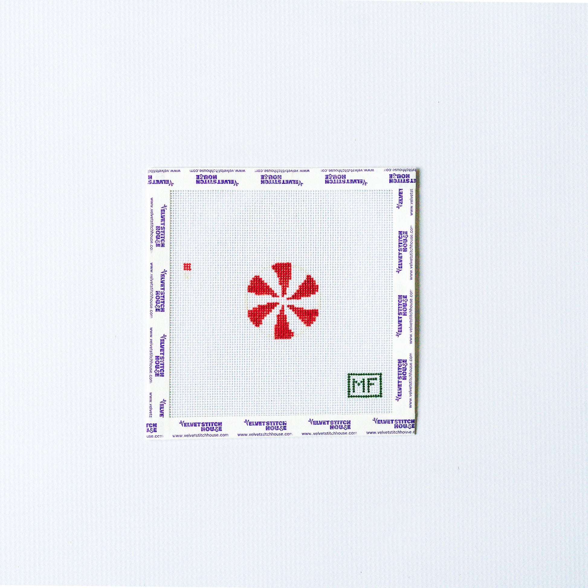 Needlepoint mini design with red and white round peppermint.